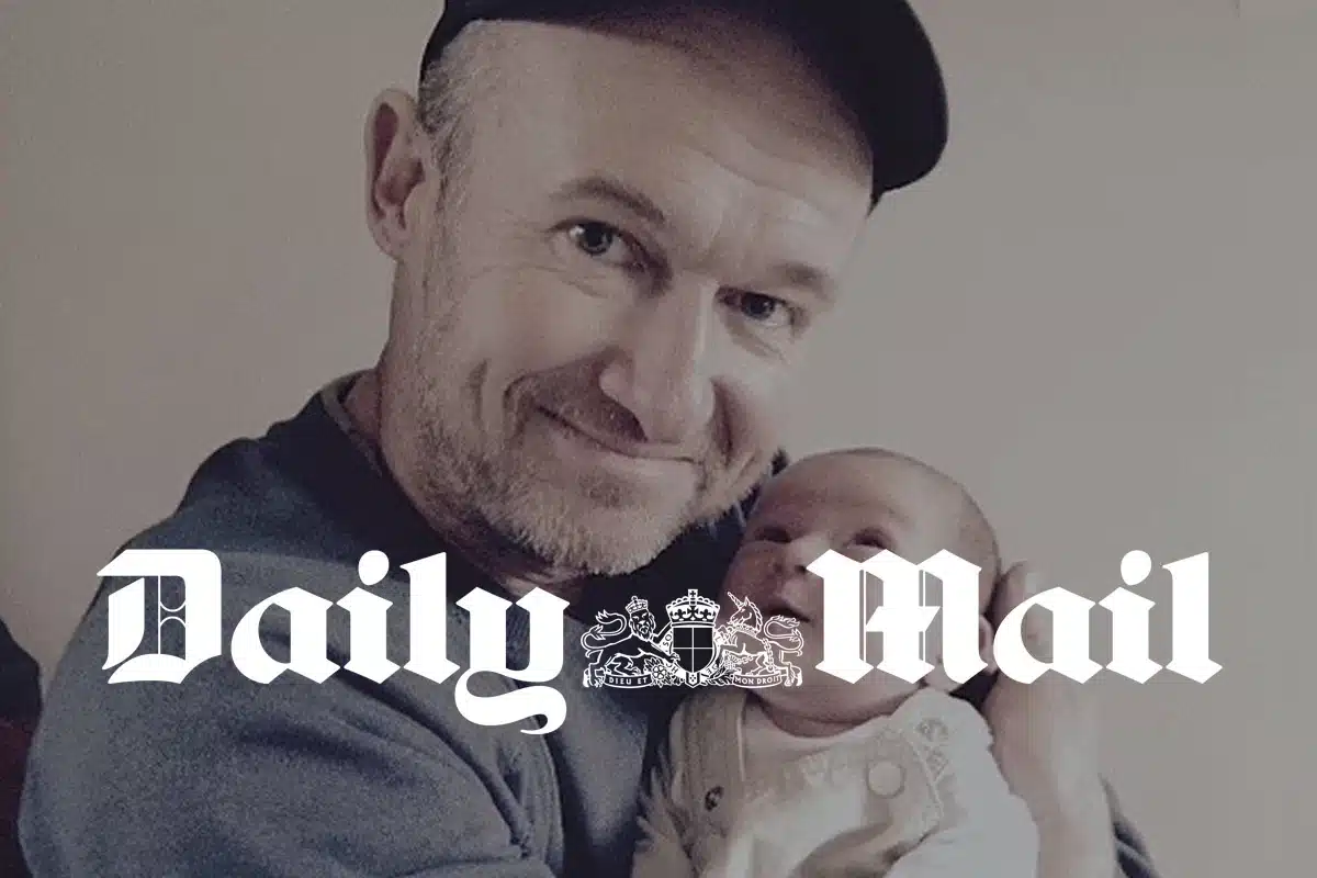 MailOnline on the platonic co-parenting boom: a man in a cap cradling a newborn, under the Daily Mail logo